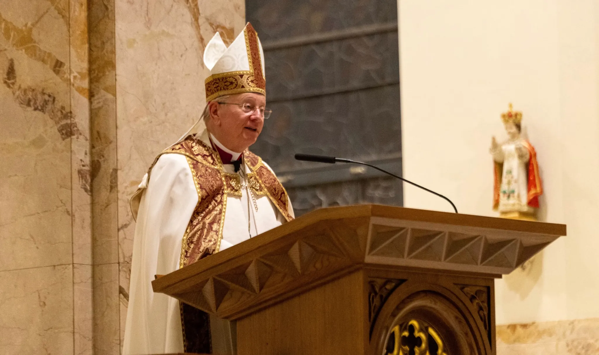 Bishop Ricken at Adele Brice Vespers reading from pulpit